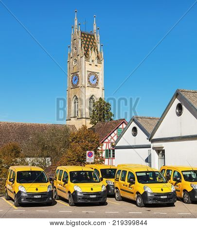 Andelfingen, Switzerland - 17 October, 2017: parked cars of Swiss Post. Swiss Post is the national postal service of Switzerland, being a public company owned by the Swiss Confederation.