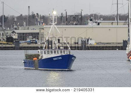 Fairhaven Massachusetts USA - December 22 2017: Lobster boat Direction eases its way toward Fairhaven dock
