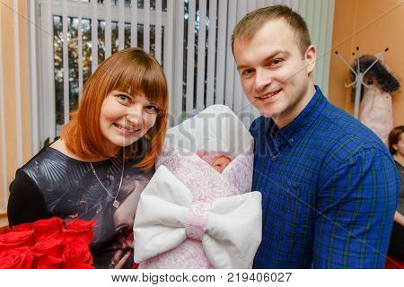 Happy Father Meets His Wife With A Newborn Baby