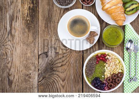 Espresso, croissant and fruit dessert for breakfast. Studio Photo