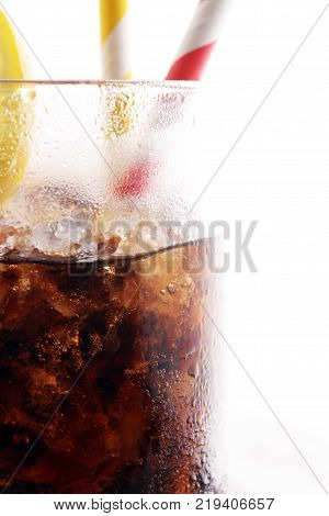Softdrink With Ice Cubes, Lemon And Straw In Glass