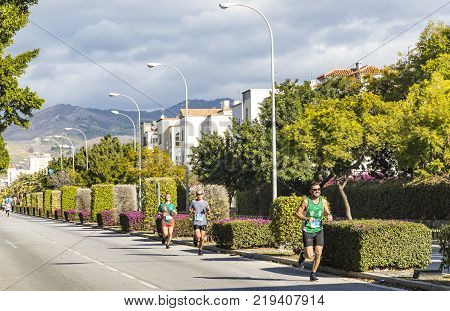 MALAGA SPAIN - DECEMBER 10 2017: Athletes run during Zurich Maraton Malaga on the streets of Malaga city Andalusia Spain. More than 3400 marathoners took part in the 8th Malaga Marathon
