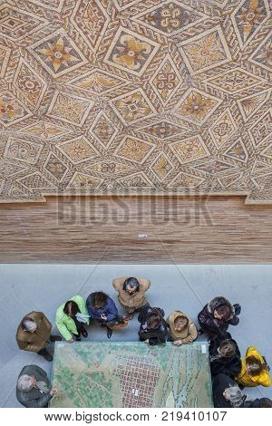 Merida Spain - December 20th 2017: Visitors observing a model of ancient Roman City of Emerita Augusta at National Roman Art Museum Spain
