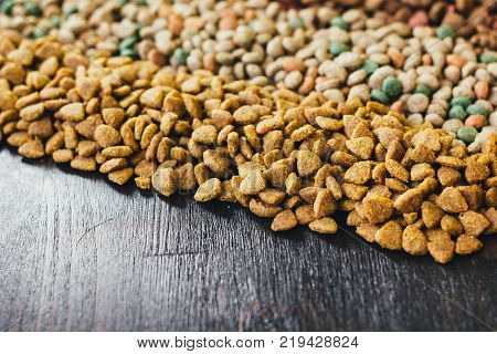Dry pet food for dogs and cats on table.