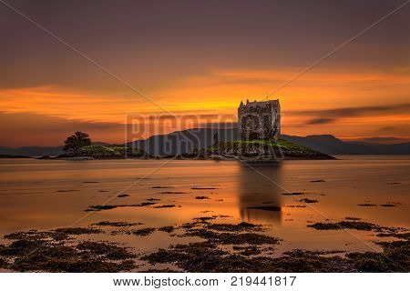 Sunset over Castle Stalker, Highlands, Scotland, United Kingdom. Long exposure and hdr processed.