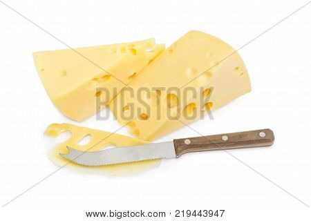 Cheese knife with slice and two pieces of Swiss-type cheese with holes on a white background