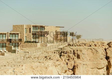 Buildings on the mountain in negev desert. Crater ramon in middle east