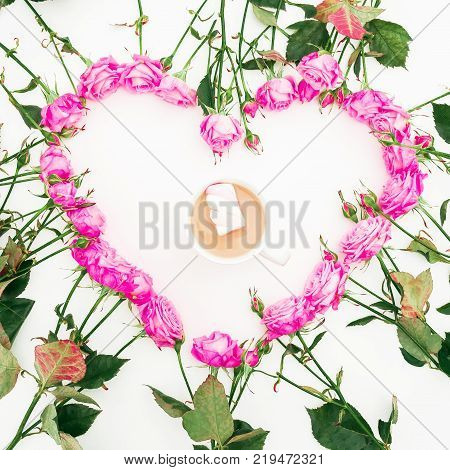 Heart made of pink roses on white background. Flat lay, top view. Valentine's background. Pattern made of flowers.