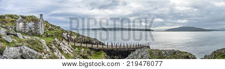 The rotten pier at Craignish point with the Sound of Jura in the background, Scotland