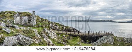 The rotten pier at Craignish point with the Sound of Jura in the background, Scotland