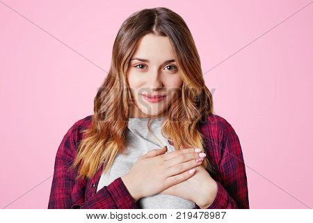 Headshot Of Unhappy Sorrorful Female Curves Lips, Looks Desperately At Camera, Being Upset To Hear B
