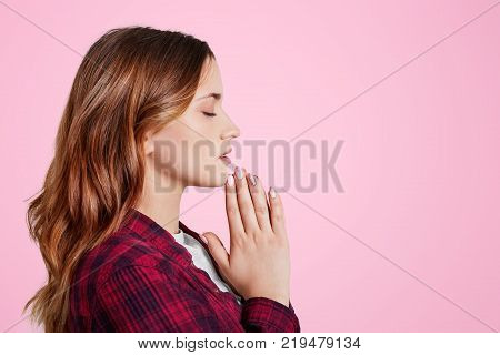 Headshot Of Unhappy Sorrorful Female Curves Lips, Looks Desperately At Camera, Being Upset To Hear B