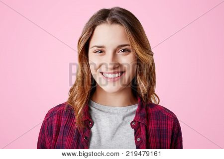 Headshot Of Unhappy Sorrorful Female Curves Lips, Looks Desperately At Camera, Being Upset To Hear B