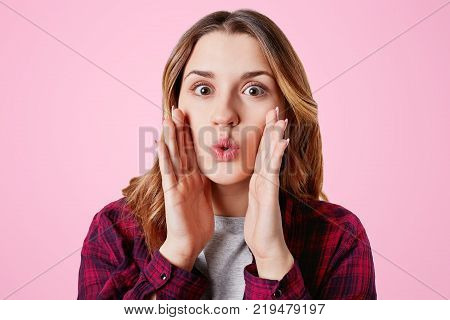 Headshot Of Unhappy Sorrorful Female Curves Lips, Looks Desperately At Camera, Being Upset To Hear B