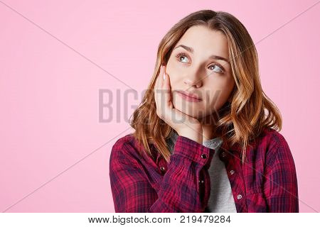 Headshot Of Unhappy Sorrorful Female Curves Lips, Looks Desperately At Camera, Being Upset To Hear B