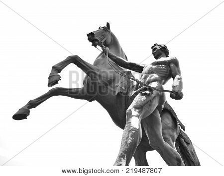 Statue of the conquest of a horse on the Anichkov Bridge in St.Petersburg Russia. Black and white.