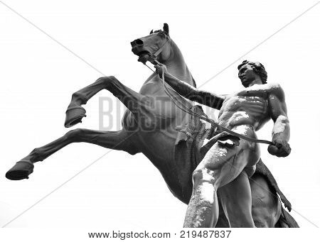 Statue of the conquest of a horse on the Anichkov Bridge in St.Petersburg Russia. Black and white.