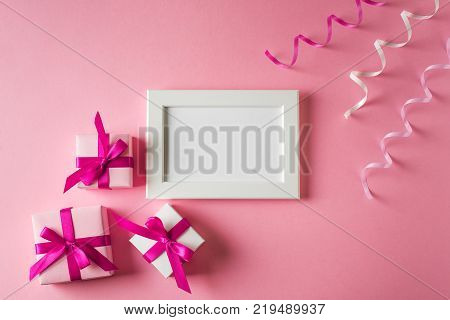 Valentines and birthday card with gift and poster on pink background. Moke up