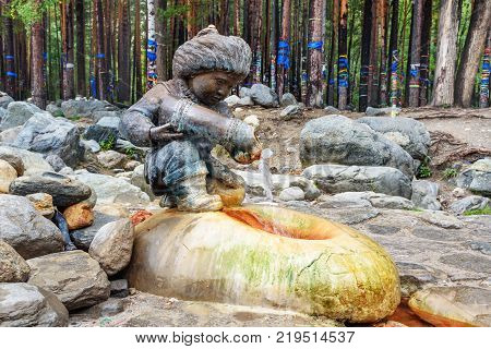 Source Of Mineral Water. Water Flows From Form Of Figures Of Boy With Jug. Arshan. Russia