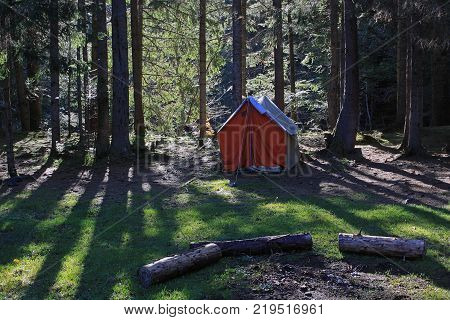 Tent in the coniferous forest in the foothills Carpathian Ukraine. Large space for writing