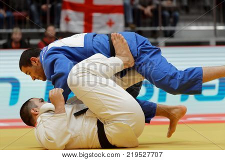 ST. PETERSBURG, RUSSIA - DECEMBER 17, 2017: Final fight Guram Tushishvili, Georgia (blue) vs David Moura, Brazil during Judo World Masters tour. Tushishvili won gold medal