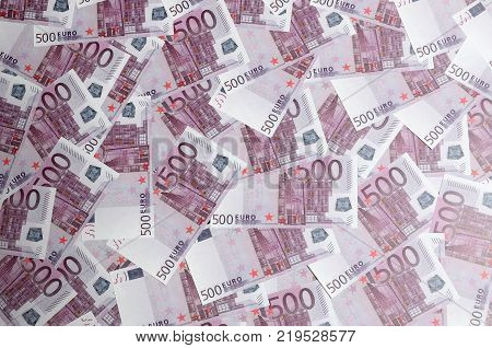 Close up background photo Amount of Five hundred notes of European Union Currency. Many pink 500 euro banknotes are adjacent. Symbolic texture photo for wealth