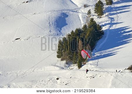 Ischgl, Austria - December 24, 2017: Austrian Alps ski resort Ischgl. Speedrider with red and gray wing skis in close proximity to a steep slope