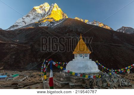 Buddhist stupa on mountain trekking path in Himalayas, Nepal.