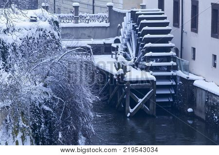 Czech Republic - Prague -  Water mill nearest Charles Bridge in winter morning during snowfall