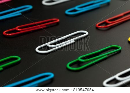 row of paper clip on black background different concept
