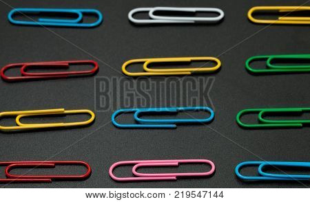 row of paper clip on black background different concept