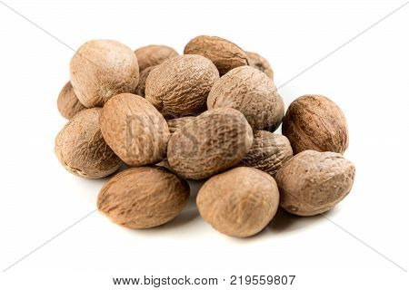 Pile Of Whole Dried Nutmeg Seed For Flavoring