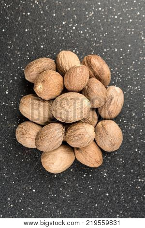 Pile Of Whole Dried Nutmeg Seed For Flavoring