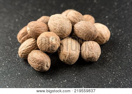 Pile Of Whole Dried Nutmeg Seed For Flavoring