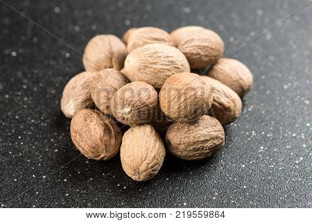 Pile Of Whole Dried Nutmeg Seed For Flavoring