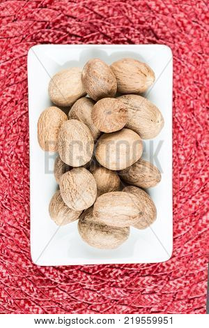Pile Of Whole Dried Nutmeg Seed For Flavoring
