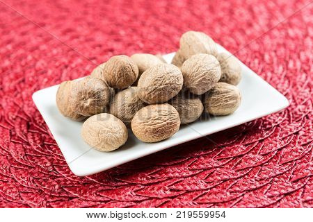 Pile Of Whole Dried Nutmeg Seed For Flavoring