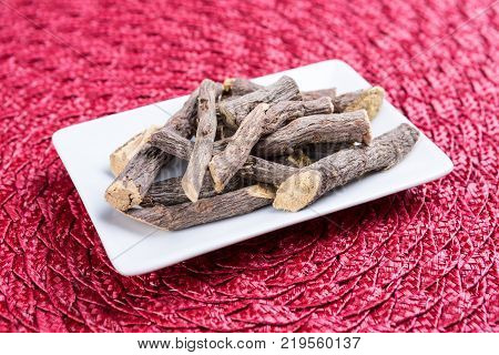Pile Of Licorice Roots On A Cloth Background