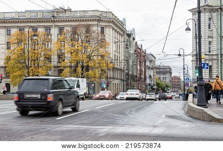 SAINT-PETERSBURG RUSSIA - OCTOBER 18 2017: The usual autumn cloudy day in St. Petersburg. Traffic of cars and pedestrians on busy Kamennoostrovsky Prospekt one of the main streets of the city.