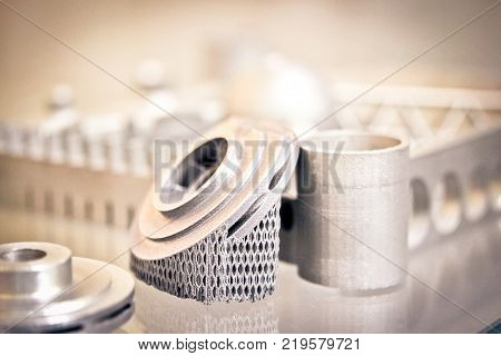 Object printed on metal 3d printer. A model created in a laser sintering machine close-up. DMLS, SLM, SLS technology. Concept of 4.0 industrial revolution. Progressive modern additive technology.