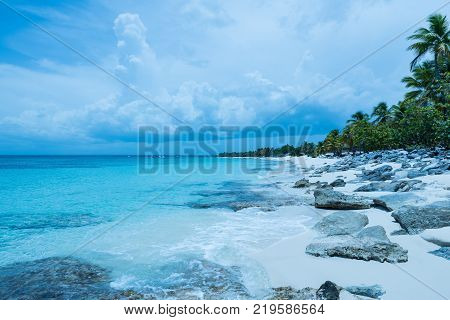 Travel photography - tropical beach with a cloudy blue sky (Catalina island, Dominican Republic).