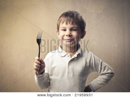 Smiling child holding a fork