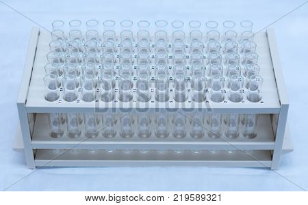 Chromatography fraction collection tubes on a rack in a lab.