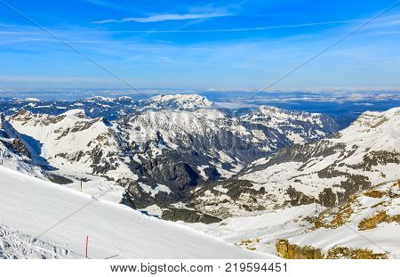 The Alps, view from the top of Mt. Titlis in Switzerland in winter. The Titlis is a mountain located on the border between the Swiss cantons of Obwalden and Bern.
