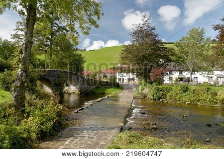 Picturesque packhorse bridge and ford through Badgworthy Water at Malmsmead, Exmoor, North Devon