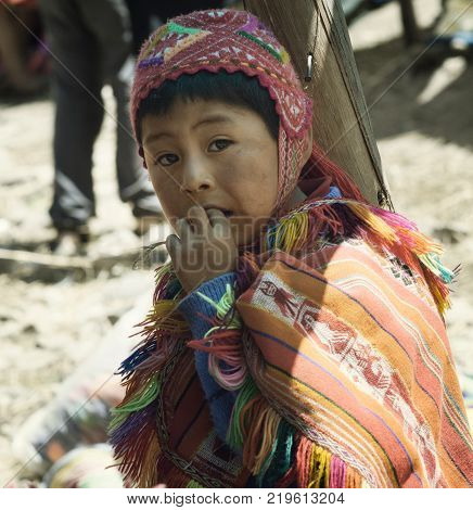 Peruvian boy dressed in colourful traditional handmade outfit. October 21 2012 - Patachancha Cuzco Peru