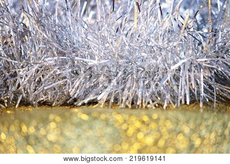 silver tinsel on a gold background for decorating a Christmas festive tree