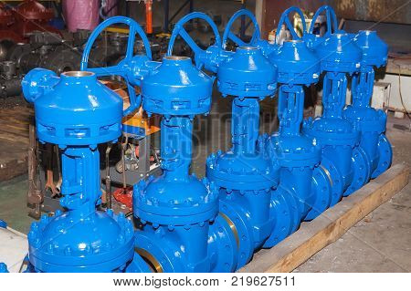 Industrial background from part of valves for power, oil or gas industry. Casting carbon steel boides. Forging stainless still parts.