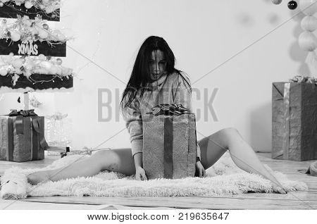 Beautiful Brunette on the Background of New Year's decoration. Fashion Beauty Portrait. Sexy Girl. Holiday Makeup.