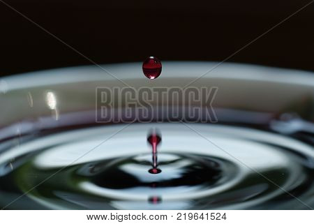 a drop in white Cup on black background